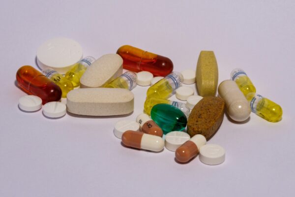 A pile of pills sitting on top of a white table