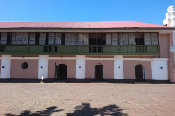 a pink and white building with a red roof