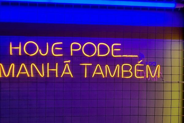 a bathroom with a neon sign above it