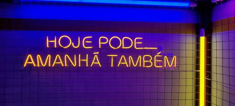 a bathroom with a neon sign above it