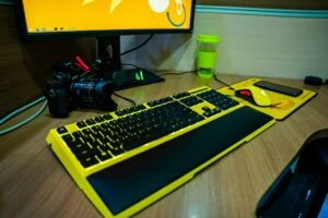 black and gray computer keyboard on brown wooden table