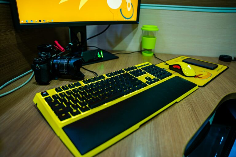 black and gray computer keyboard on brown wooden table