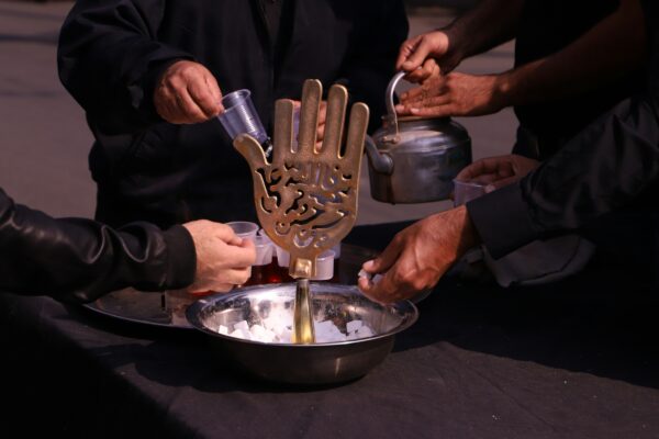 person holding stainless steel container