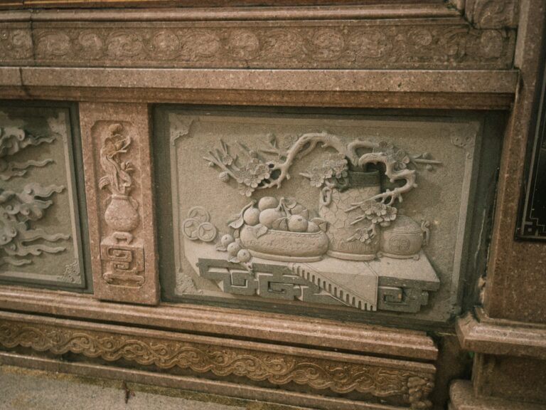 Stone relief depicts intricate asian carvings.