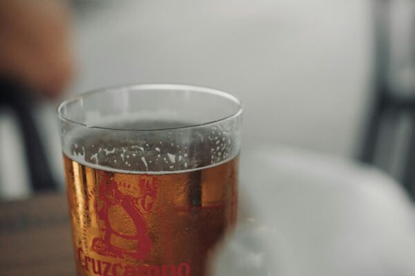 A glass of beer sitting on top of a table