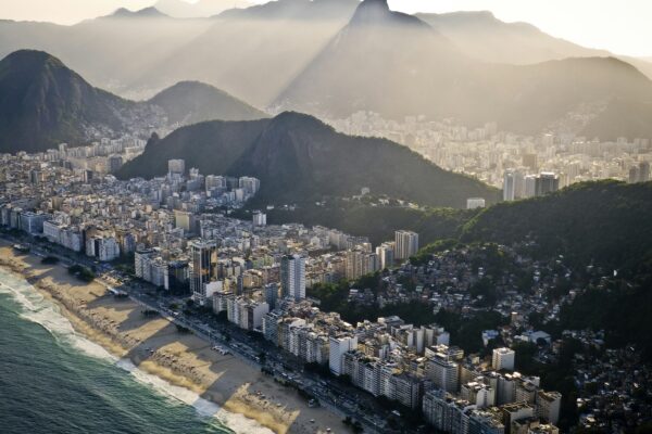 an aerial view of a city with mountains in the background