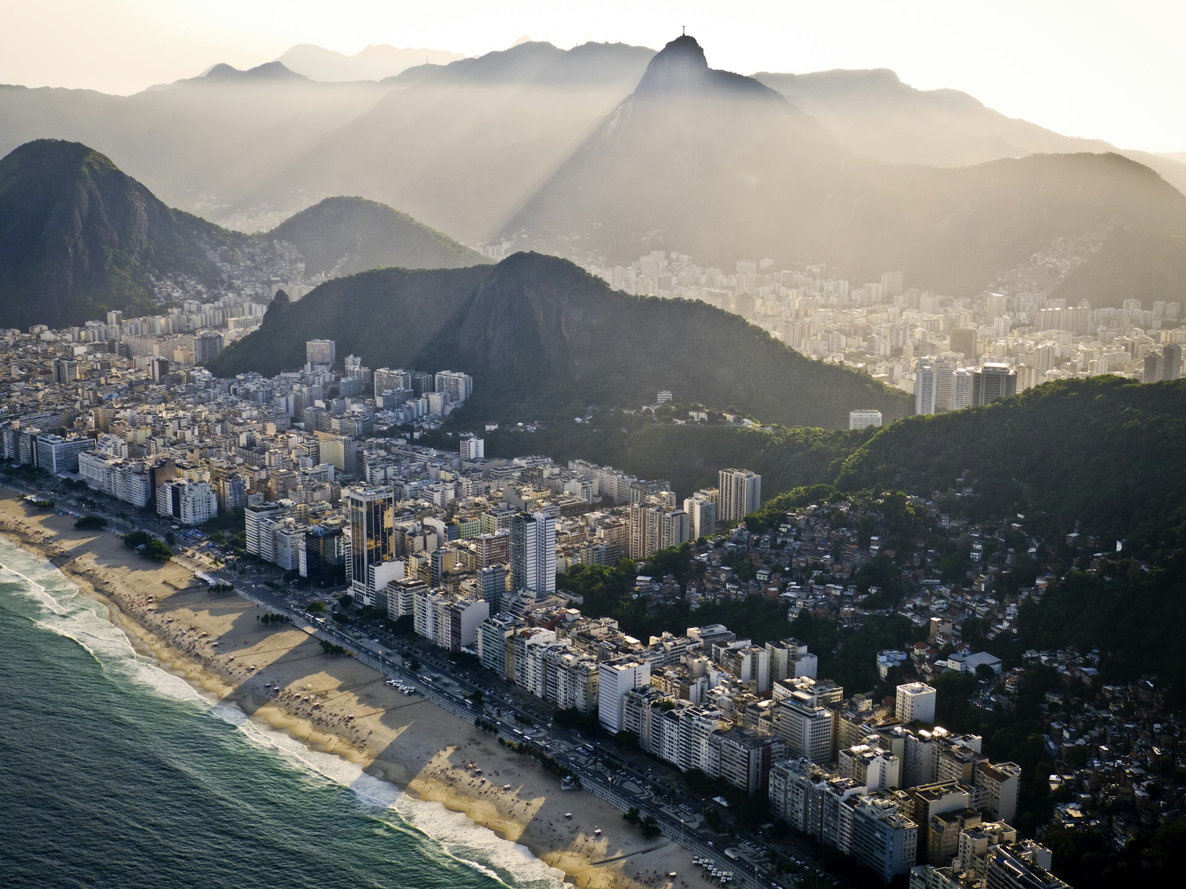 an aerial view of a city with mountains in the background