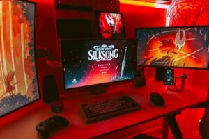 Gaming setup with multiple monitors displaying game art.