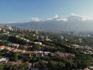 An aerial view of a city with mountains in the background