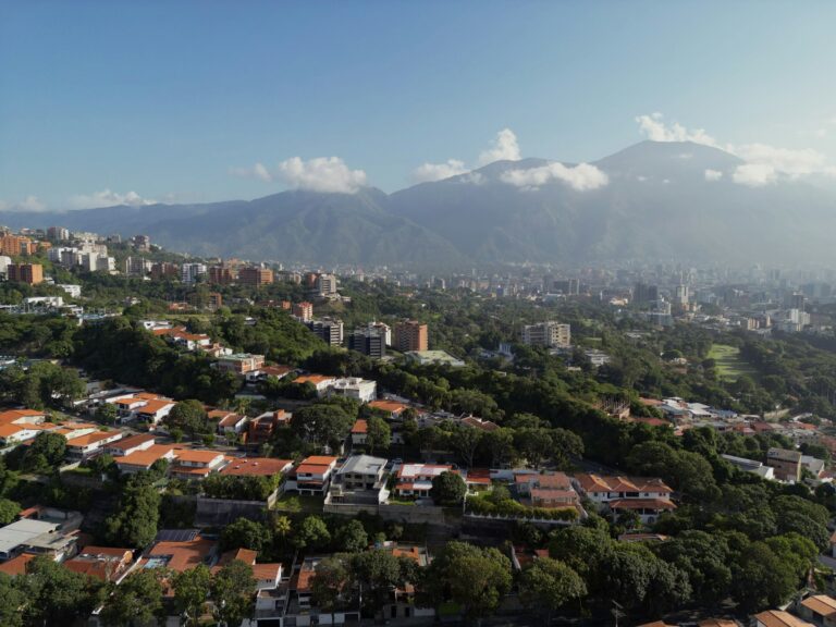 An aerial view of a city with mountains in the background