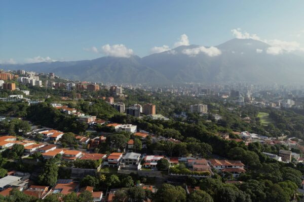 An aerial view of a city with mountains in the background