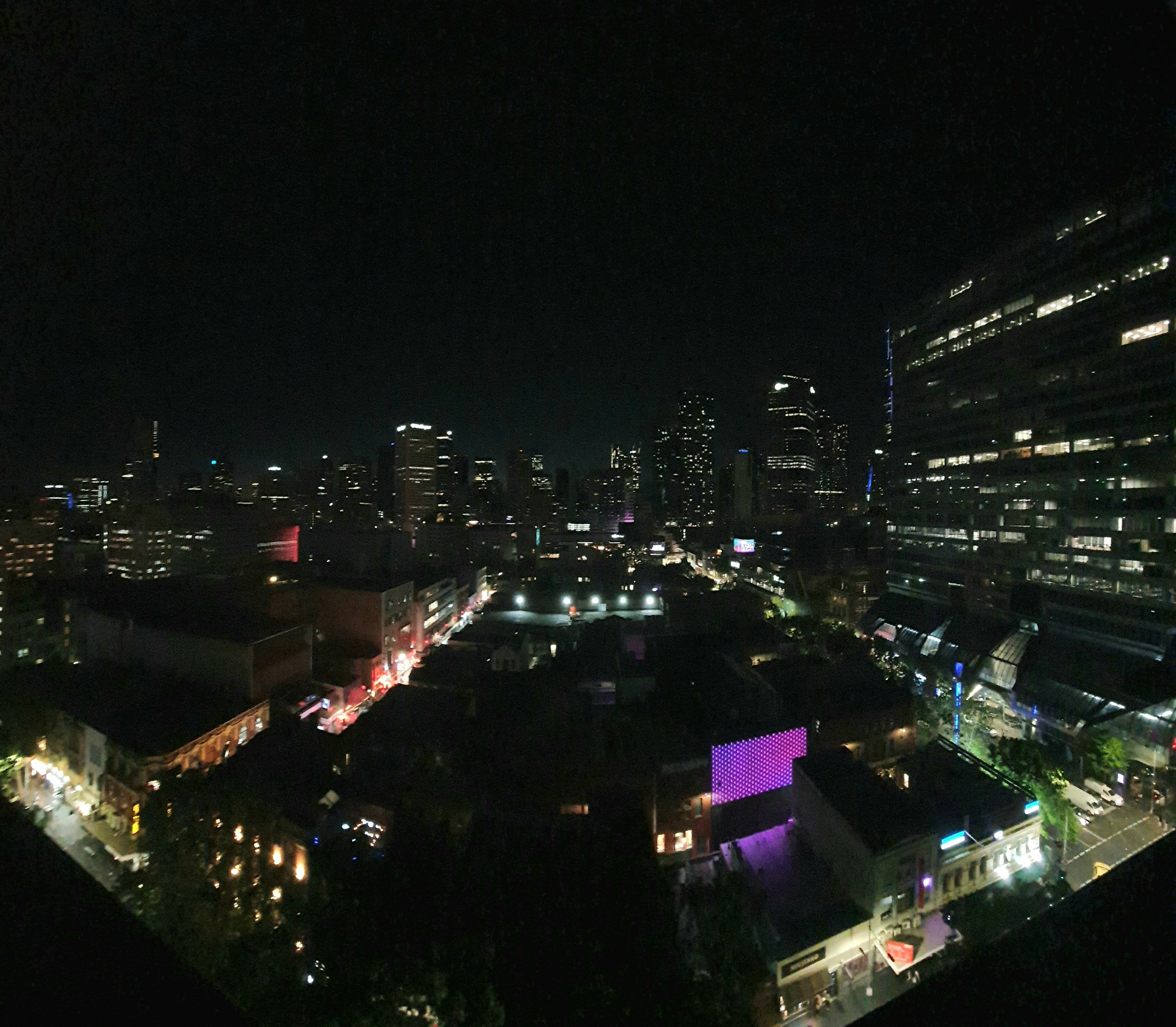 a view of a city at night from the top of a building