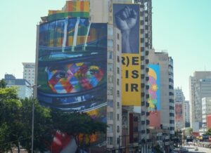 Colorful murals decorate a high-rise building.