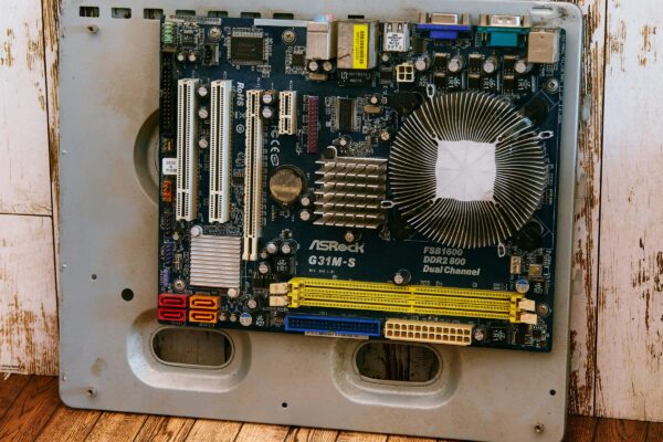a computer motherboard sitting on top of a wooden floor