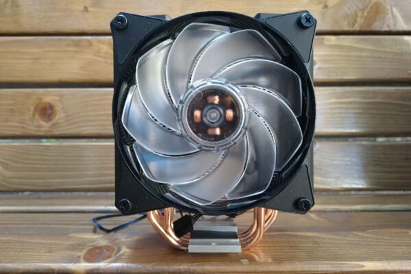 a computer fan sitting on top of a wooden table