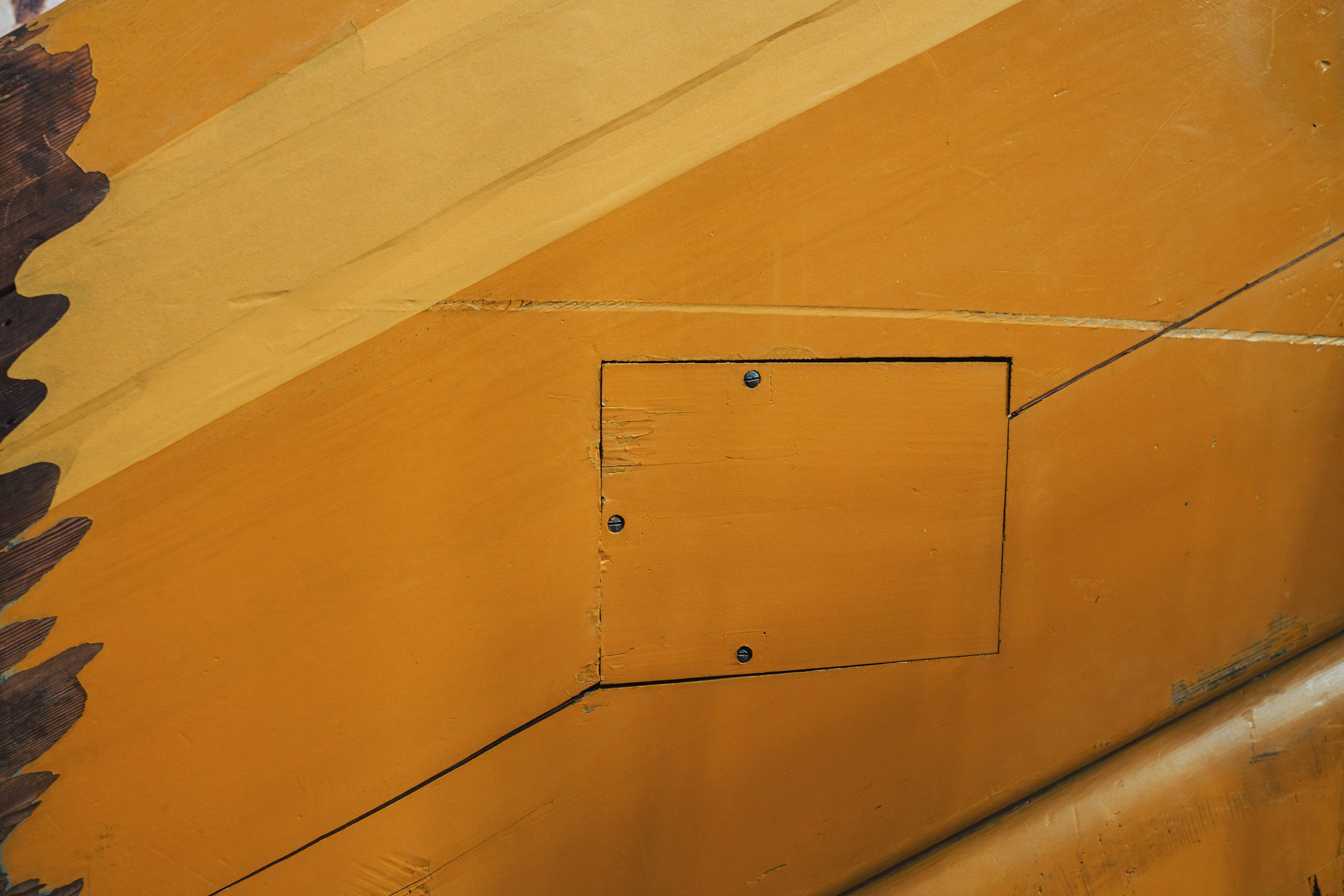 A close up of the side of a yellow airplane