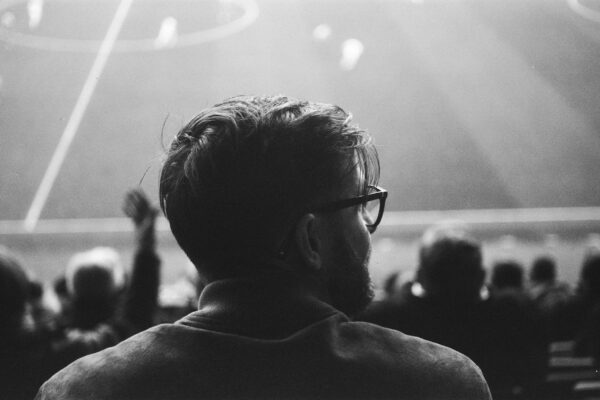 a black and white photo of a man at a soccer game