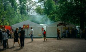 a group of people standing around a tent