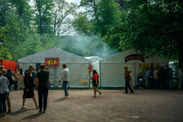a group of people standing around a tent