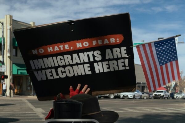 Protest sign reads immigrants are welcome here