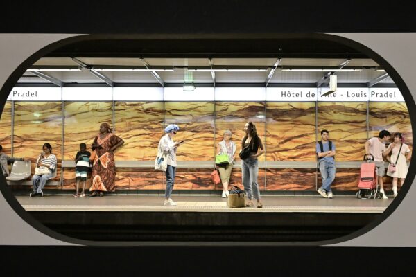 A group of people standing on a train platform