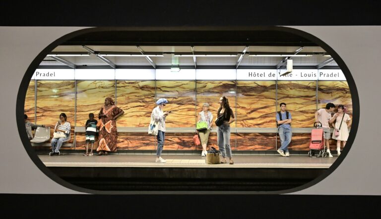 A group of people standing on a train platform