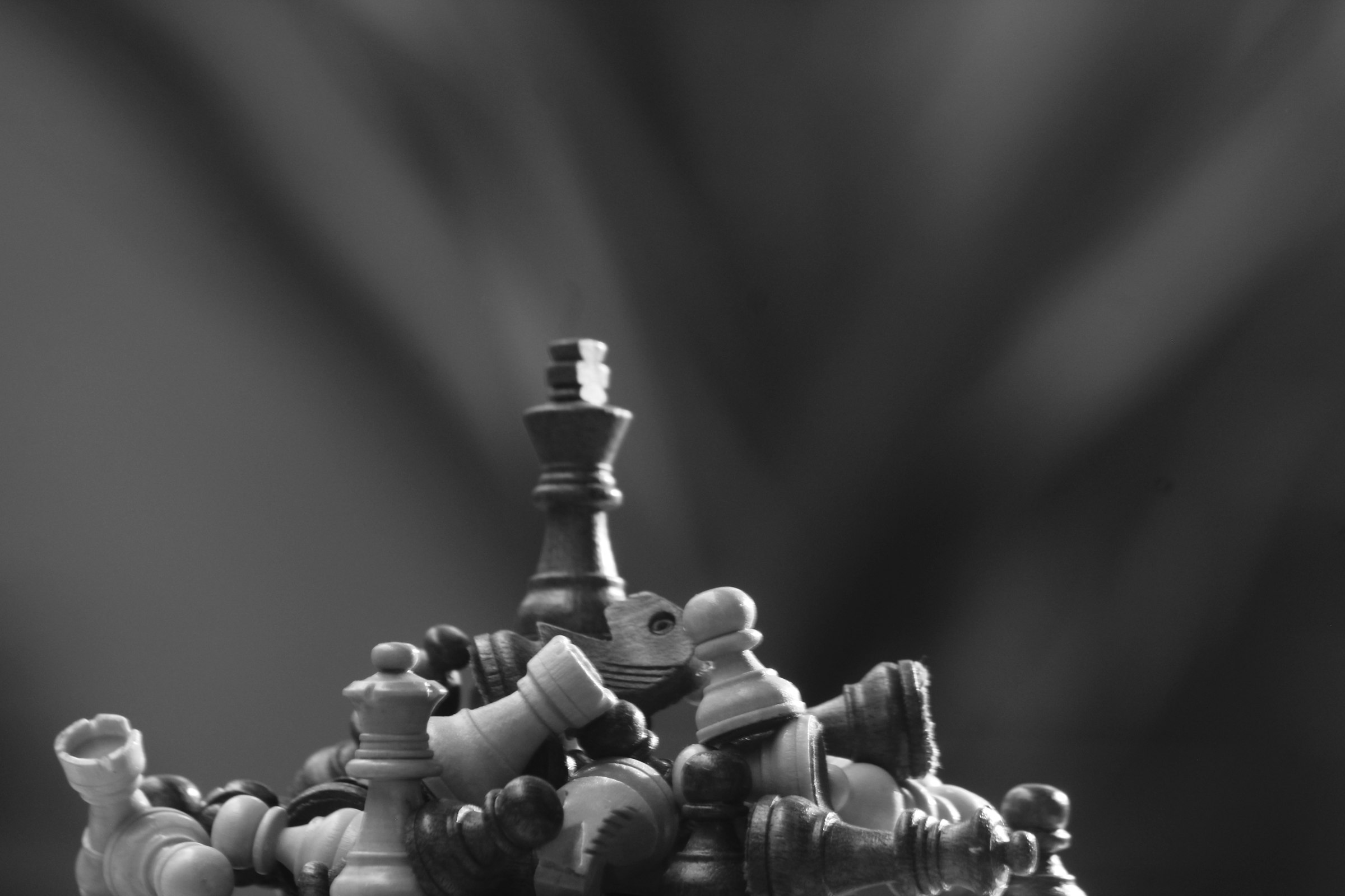 A black and white photo of a chess set