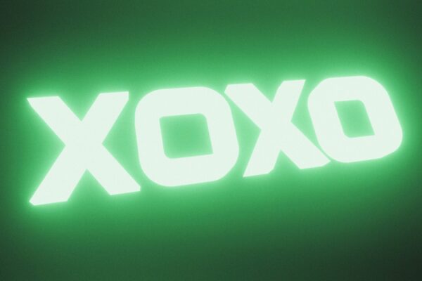 Glowing green xoxo text on dark background