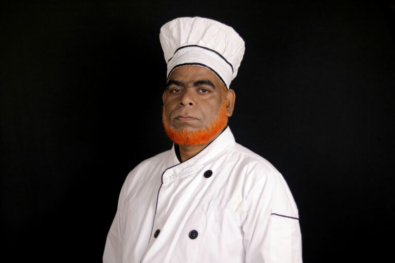 A chef in a white uniform and hat
