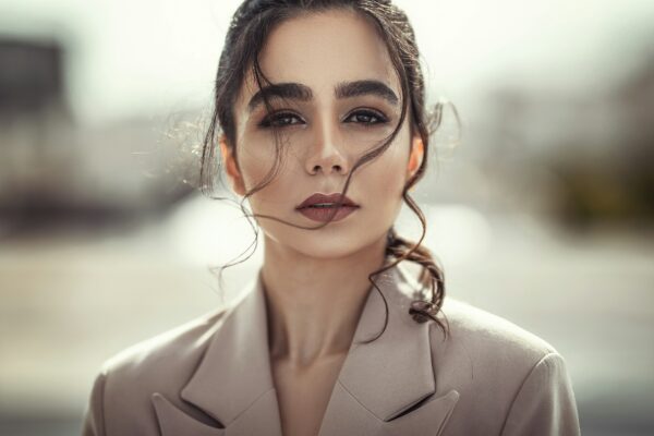 woman wearing grey peaked suit jacket