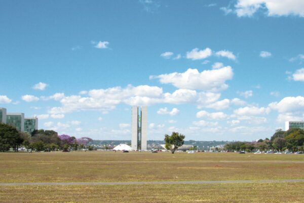green grass field under blue sky and white clouds during daytime