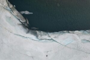 an aerial view of an iceberg and a body of water