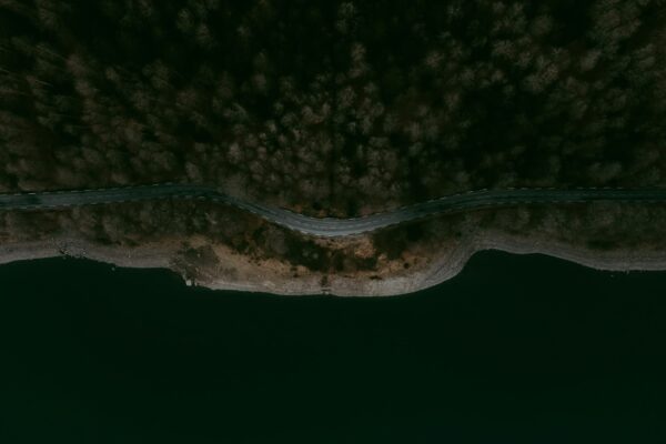 an aerial view of a road going through a body of water