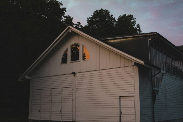 a white house with a tree in the background