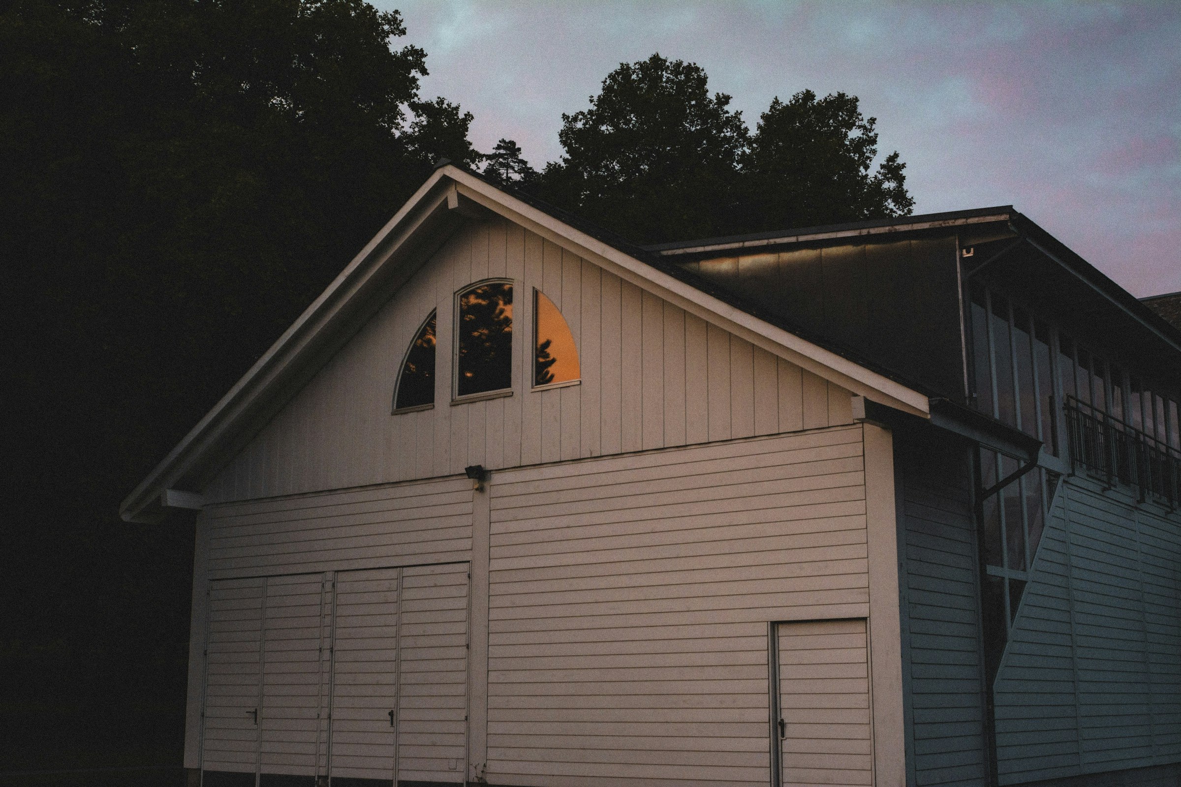 a white house with a tree in the background
