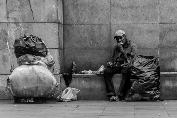 man sitting beside wall