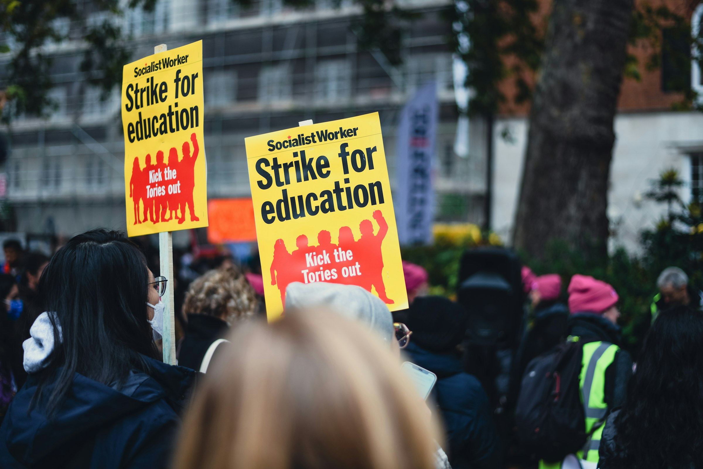 a group of people holding up yellow signs
