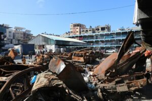 A man standing next to a pile of junk