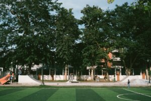 A soccer field in front of a large building