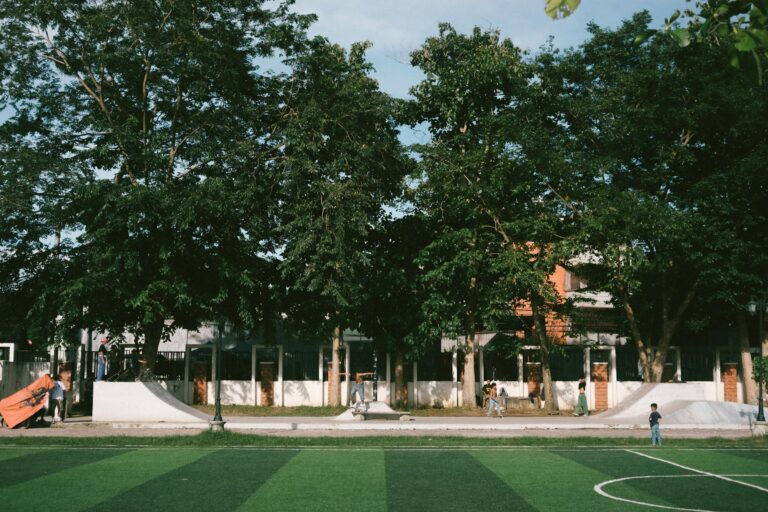 A soccer field in front of a large building