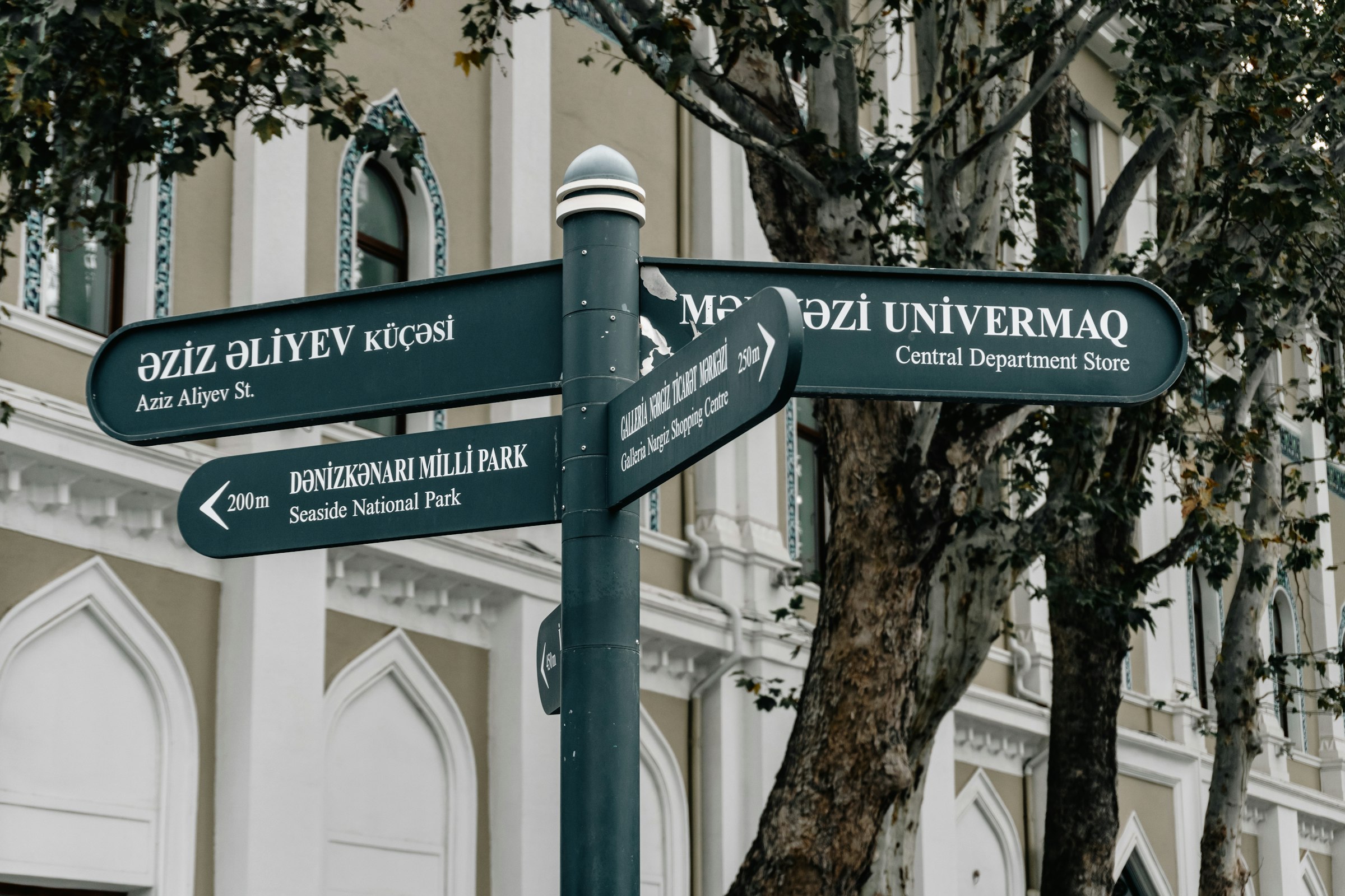 Street signpost with directions to various locations.