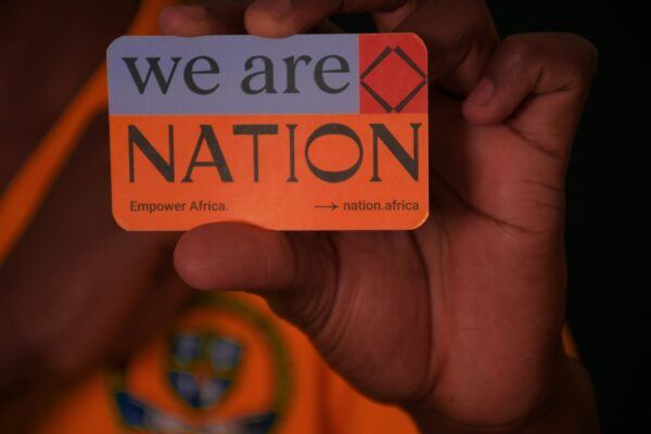 a person holding a sticker that says we are nation