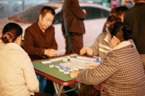 People are playing a game of mahjong together.