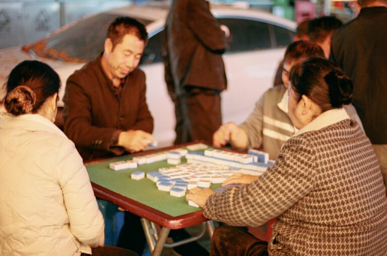 People are playing a game of mahjong together.
