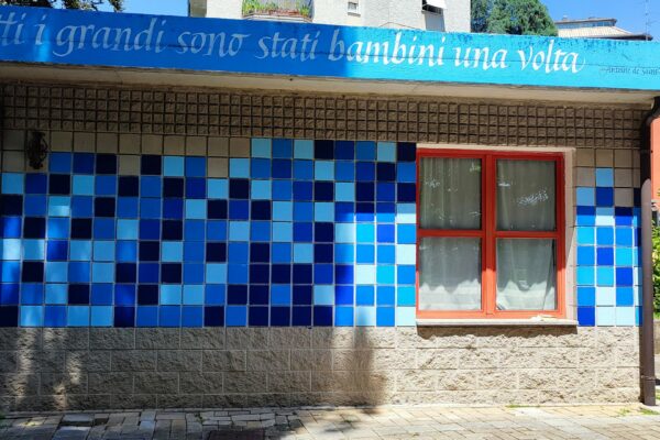 a blue and white building with a red window