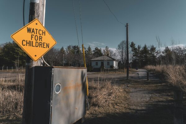 a watch for children sign on a telephone pole