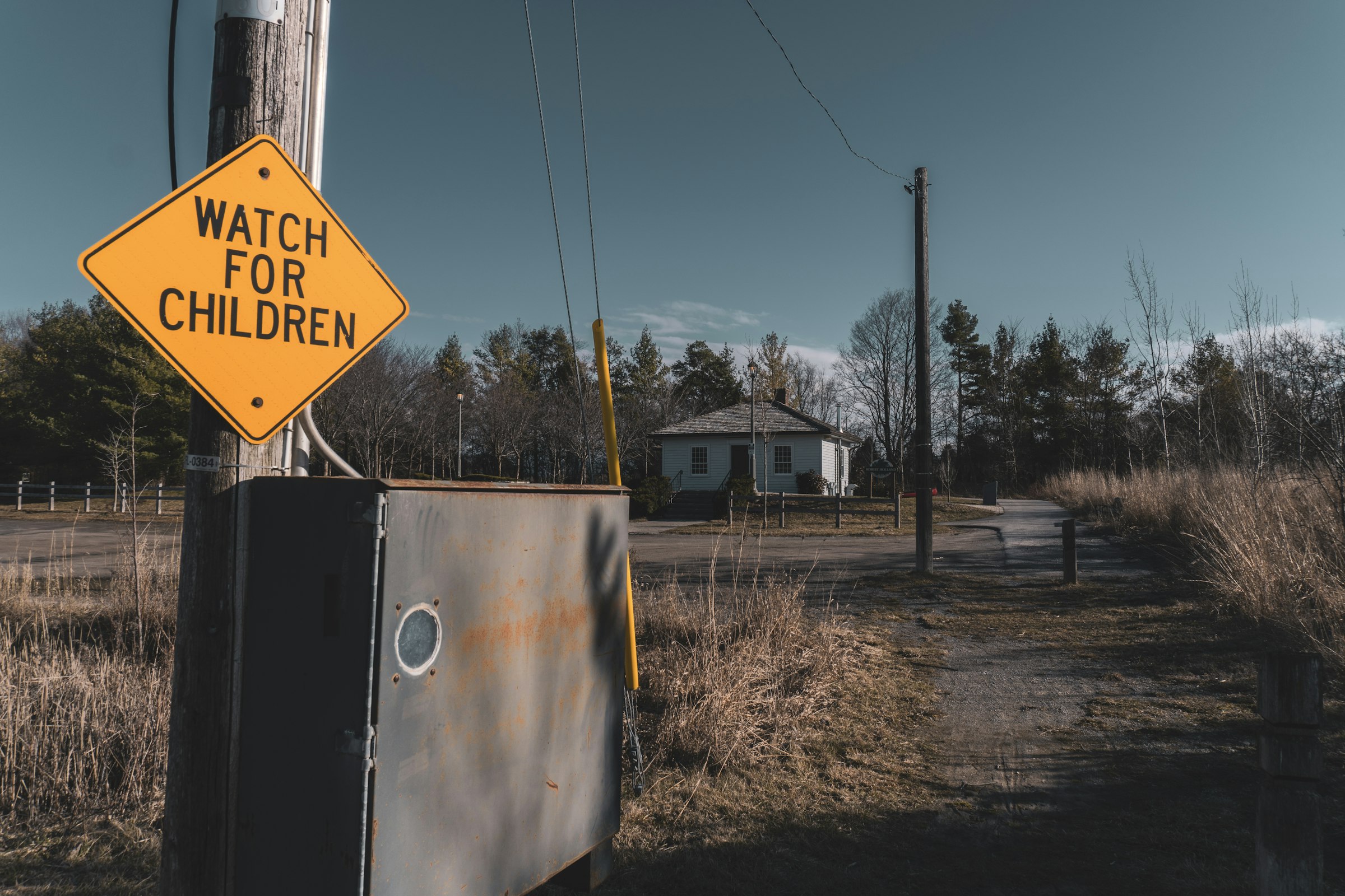a watch for children sign on a telephone pole
