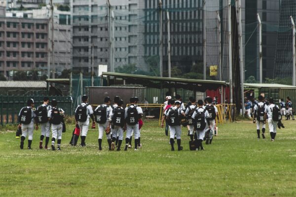 people in black and white uniform on green grass field during daytime