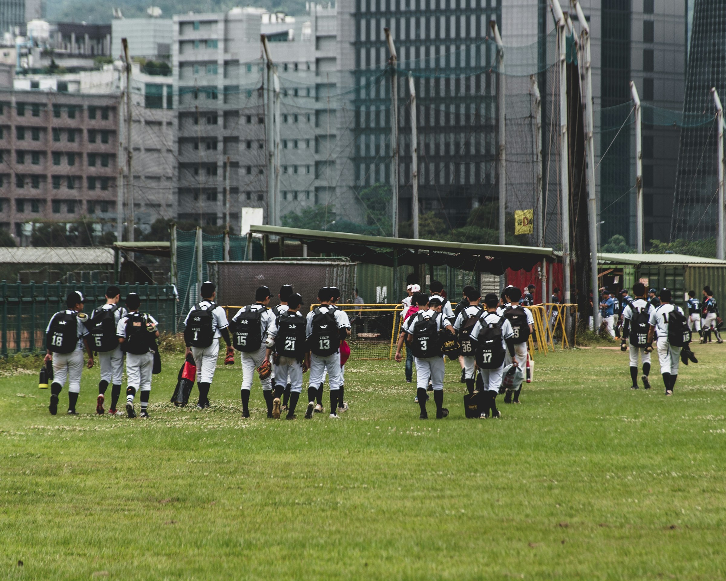 people in black and white uniform on green grass field during daytime