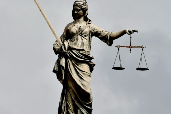 A statue of lady justice holding a sword and a scale